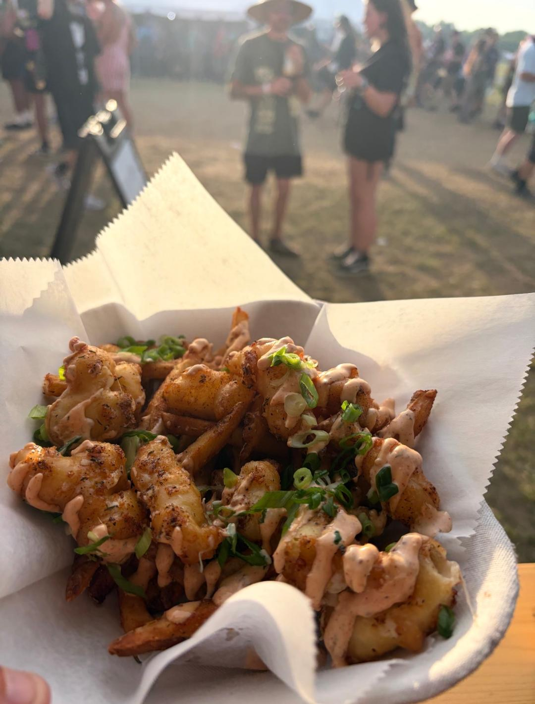 Cajun cheese curds and fries basket at an outdoor festival